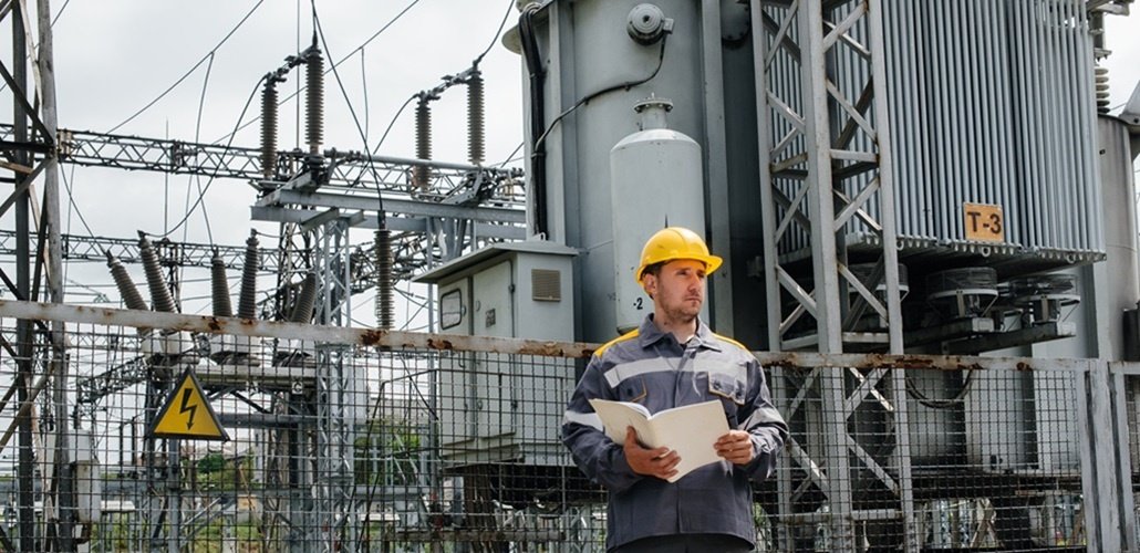 the,energy,engineer,inspects,the,equipment,of,the,substation.,power